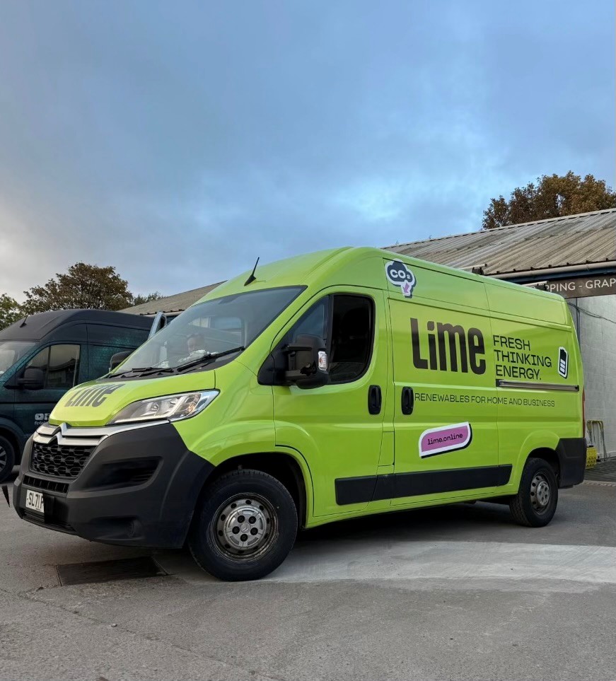 A bright green delivery van with the logo 'Lime' and the text 'FRESH THINKING ENERGY' parked in an outdoor area, surrounded by a cloudy sky.